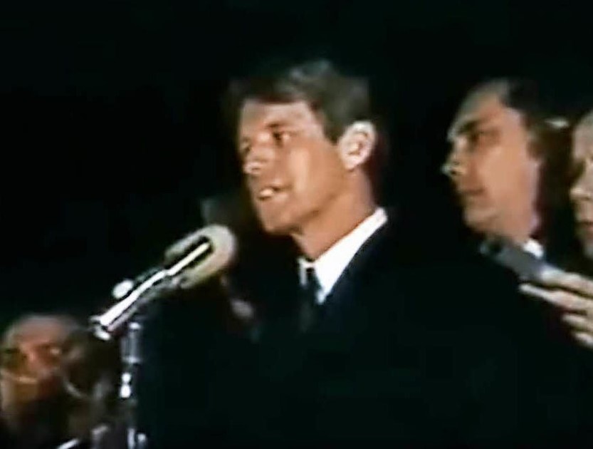 Robert Kennedy speaks in t to supporters in the dark